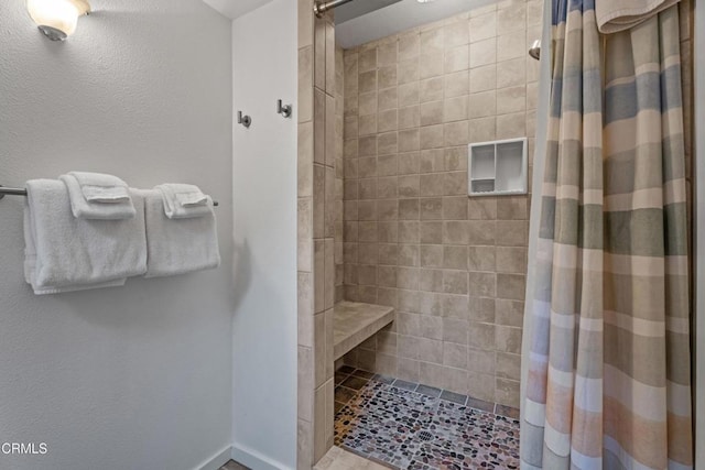 bathroom featuring a tile shower