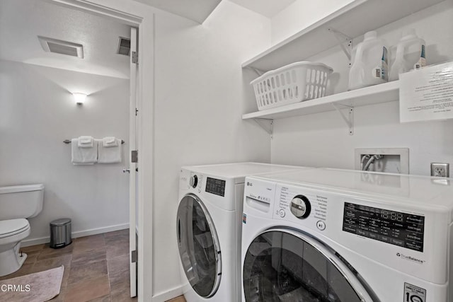 laundry room with washer and clothes dryer, laundry area, visible vents, and baseboards