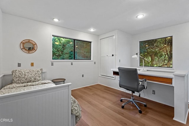 bedroom featuring recessed lighting, multiple windows, and wood finished floors