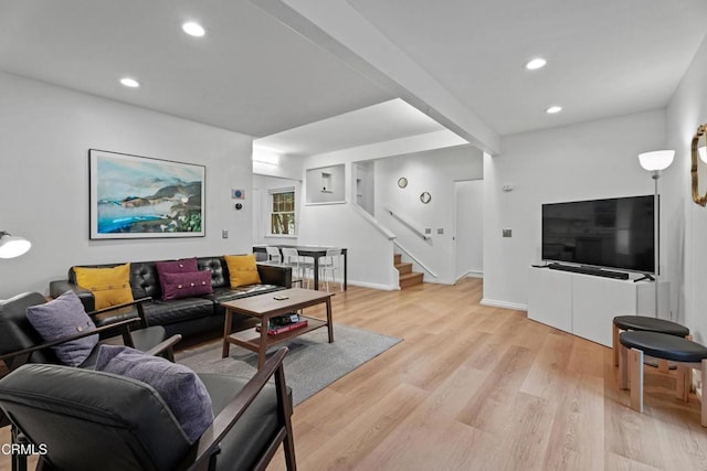 living room with light wood finished floors, baseboards, stairway, beamed ceiling, and recessed lighting