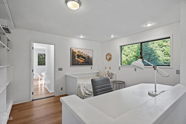 home office featuring recessed lighting, mail area, baseboards, and wood finished floors