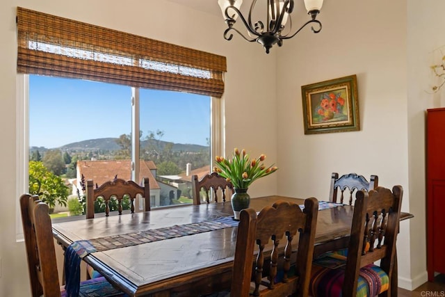 dining area with a notable chandelier, a mountain view, and a wealth of natural light