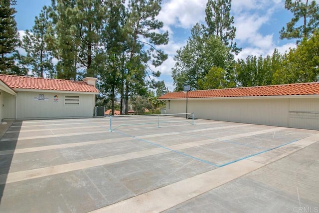 surrounding community with a tennis court