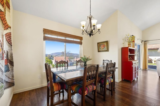 dining space with a notable chandelier, lofted ceiling, dark wood-type flooring, and baseboards