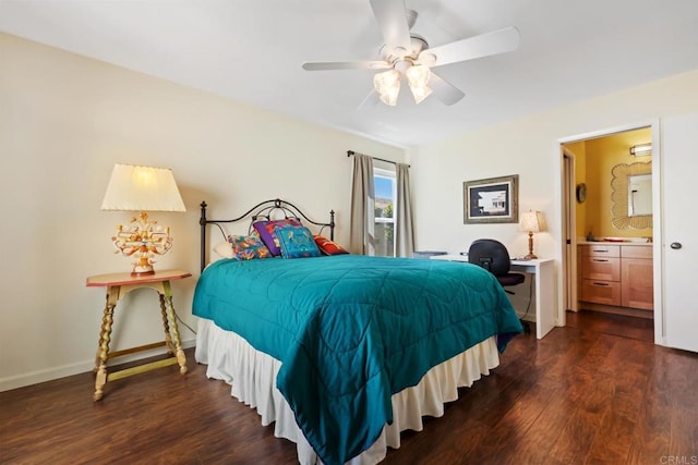 bedroom featuring a ceiling fan, ensuite bath, baseboards, and dark wood-style flooring