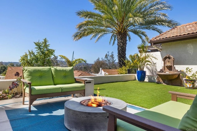 view of patio / terrace featuring an outdoor living space with a fire pit