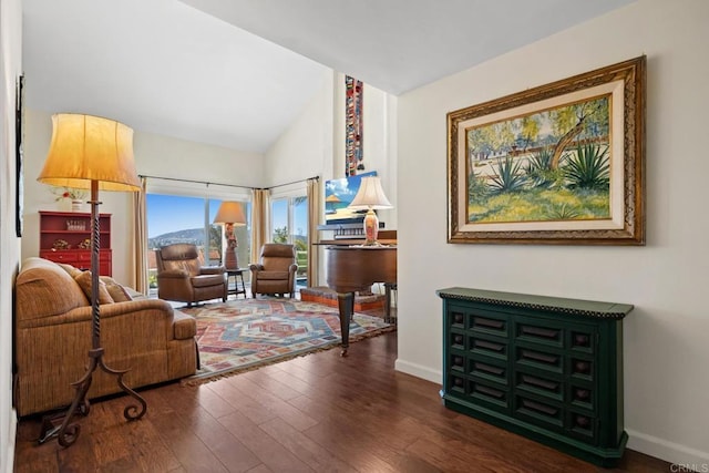 living room with dark wood-style floors, baseboards, and lofted ceiling