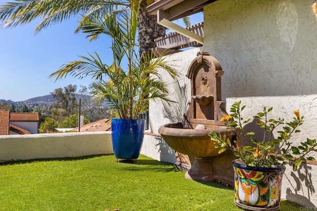 view of yard featuring a mountain view and a balcony