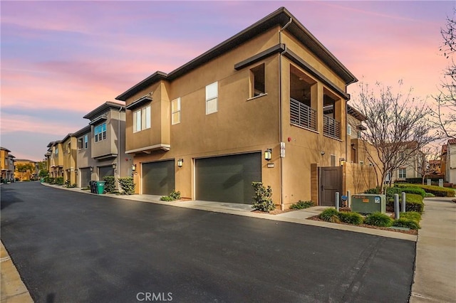 exterior space featuring an attached garage and a residential view