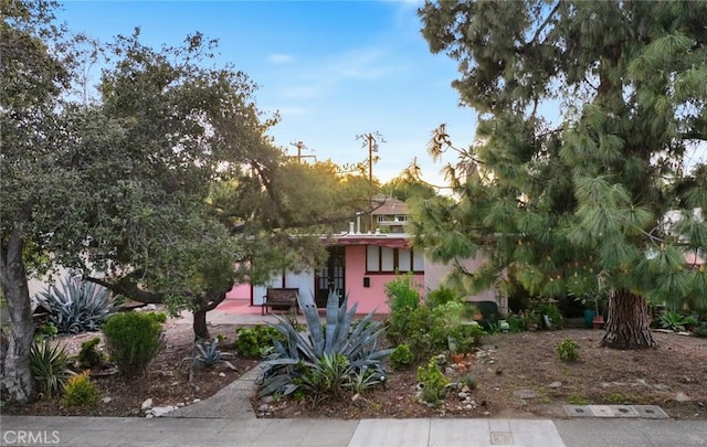 obstructed view of property featuring stucco siding and french doors