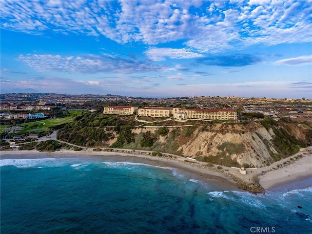 birds eye view of property featuring a beach view and a water view