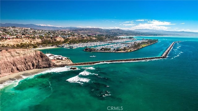 birds eye view of property with a water and mountain view