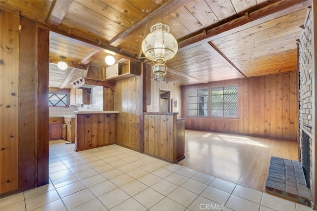 kitchen featuring beamed ceiling, a healthy amount of sunlight, and wooden ceiling