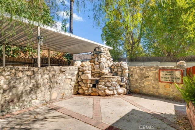 view of patio featuring fence