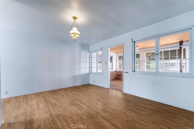 empty room featuring baseboards and wood finished floors