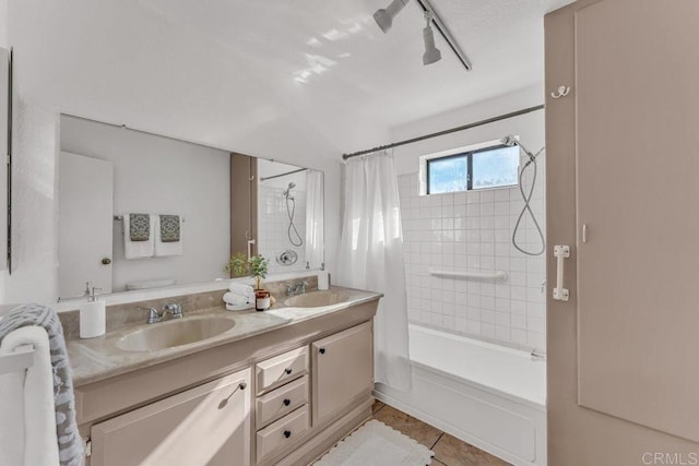 bathroom featuring tile patterned flooring, double vanity, shower / bath combo, and a sink