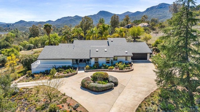 exterior space featuring curved driveway and a mountain view