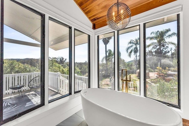 unfurnished sunroom featuring a chandelier, wooden ceiling, and lofted ceiling