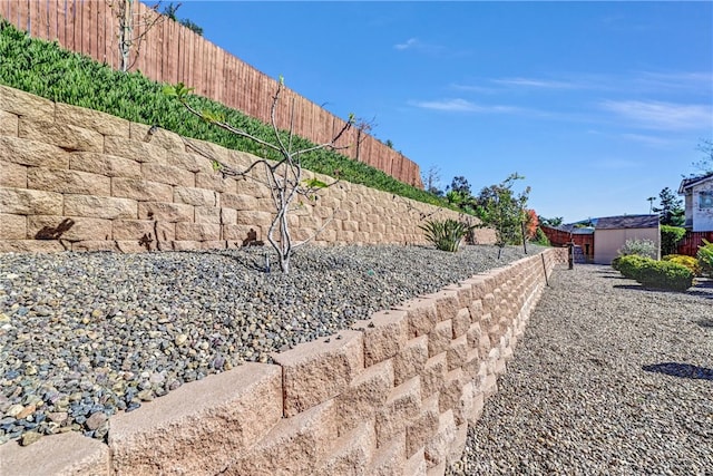 view of yard with an outdoor structure and a fenced backyard