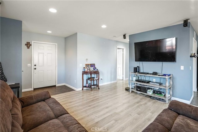 living room featuring recessed lighting, wood finished floors, and baseboards