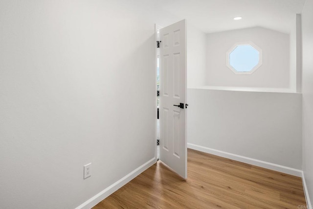 interior space featuring recessed lighting, baseboards, and wood finished floors