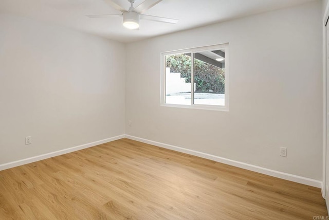 unfurnished room featuring baseboards, light wood finished floors, and ceiling fan