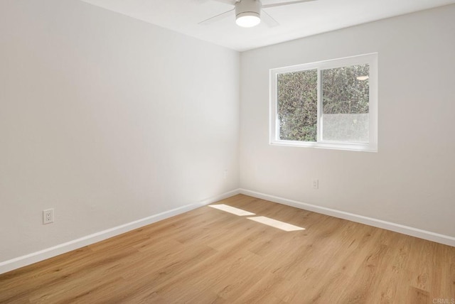 empty room with baseboards, light wood-type flooring, and ceiling fan