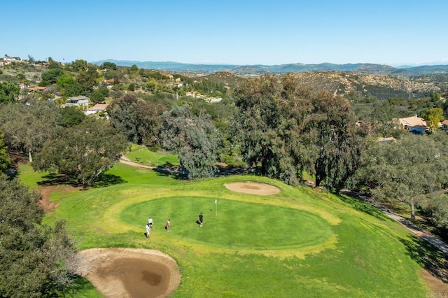 surrounding community with golf course view and a mountain view