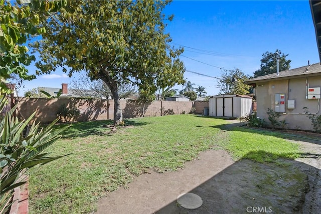 view of yard featuring a fenced backyard, a storage shed, and an outdoor structure