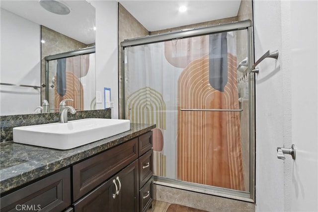 bathroom with an enclosed shower and vanity