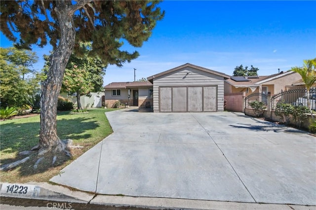 ranch-style house featuring a gate, fence, driveway, an attached garage, and a front lawn