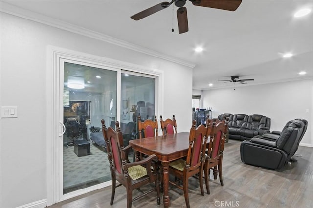 dining space with crown molding, baseboards, ceiling fan, recessed lighting, and light wood-style floors