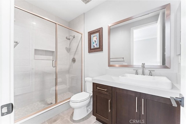 bathroom featuring toilet, a stall shower, and vanity