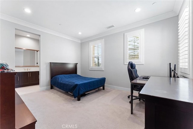 bedroom featuring visible vents, crown molding, baseboards, light carpet, and a sink