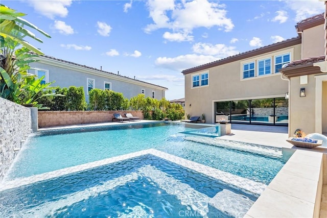 view of pool with a jacuzzi, a patio area, and a fenced in pool