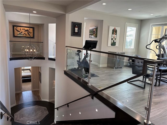 interior space with a notable chandelier, recessed lighting, baseboards, and wood finished floors