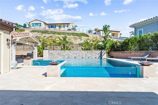 view of swimming pool with a patio area, fence, and a fenced in pool