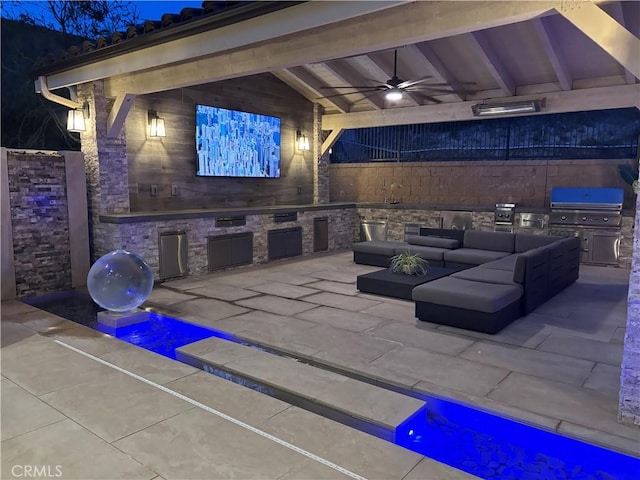 view of patio / terrace with outdoor lounge area, a grill, ceiling fan, and an outdoor kitchen