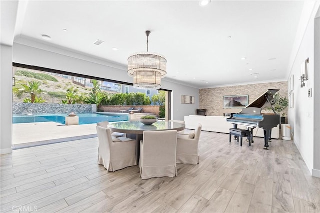 dining space featuring crown molding, light wood-style flooring, recessed lighting, and visible vents