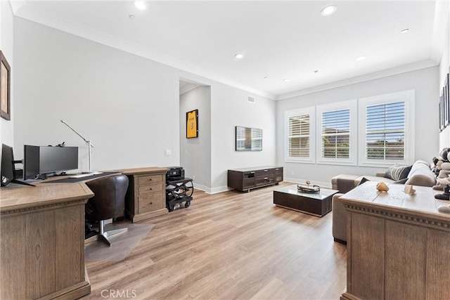 office space featuring visible vents, baseboards, recessed lighting, crown molding, and light wood-type flooring