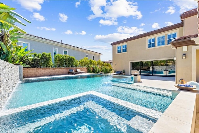 view of swimming pool with a patio, a fenced in pool, and a hot tub