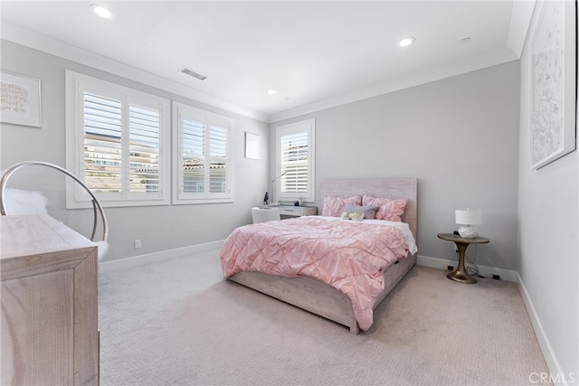 bedroom with light carpet, visible vents, baseboards, and ornamental molding