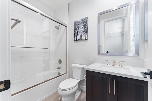 full bathroom with vanity, tile patterned floors, toilet, and combined bath / shower with glass door