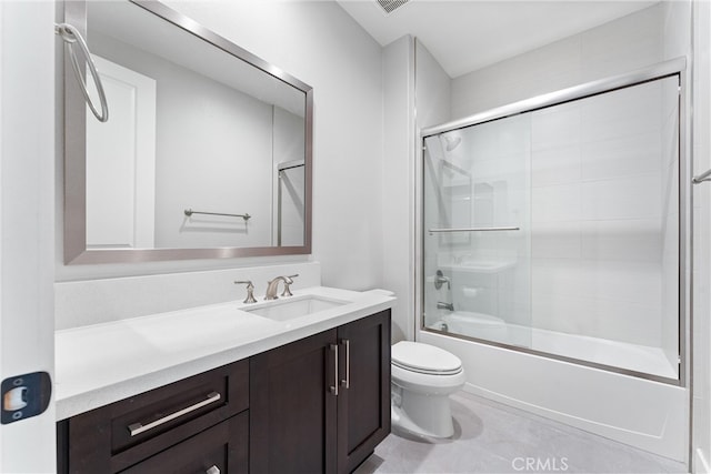 full bath with vanity, toilet, combined bath / shower with glass door, and tile patterned flooring