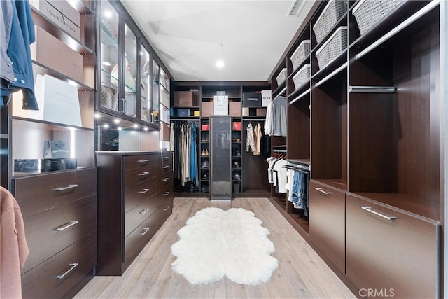 spacious closet featuring visible vents and light wood-style flooring