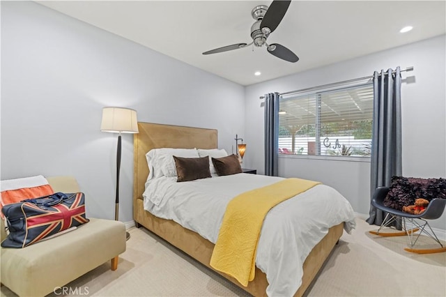 bedroom featuring light carpet, recessed lighting, baseboards, and ceiling fan