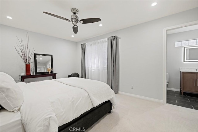 bedroom featuring light carpet, recessed lighting, ensuite bath, and baseboards