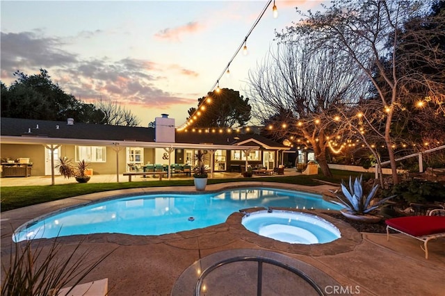 view of pool with a pool with connected hot tub and a patio area