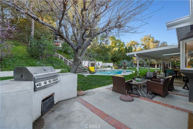 view of patio featuring an outdoor living space, a fenced in pool, exterior kitchen, a grill, and a ceiling fan