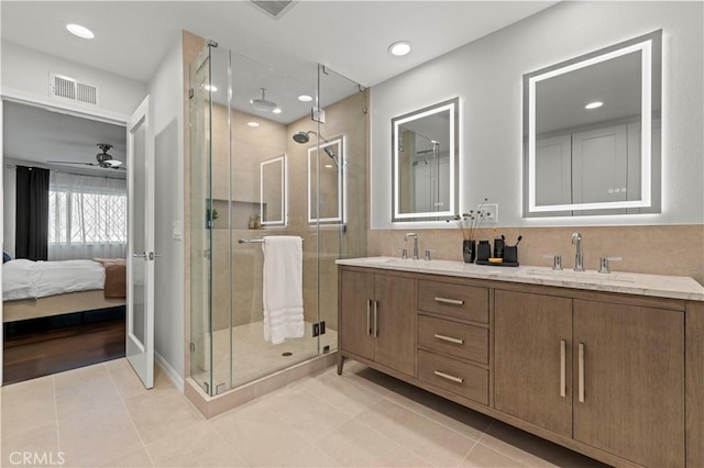 bathroom featuring a sink, visible vents, a shower stall, and tile patterned floors